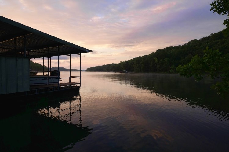 Boat dock silhouetted against the sunrise